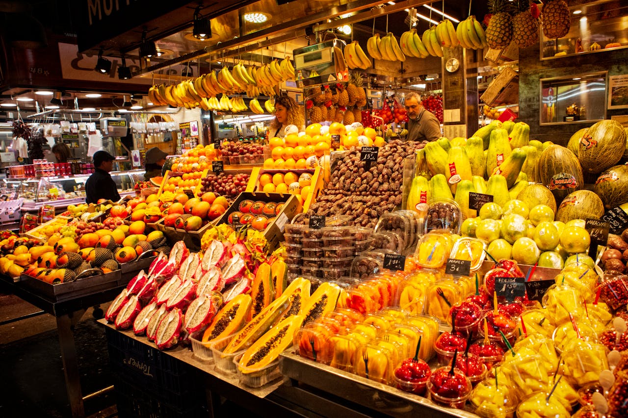 Colorful fresh fruit display at a lively local market stall, showcasing diverse produce.